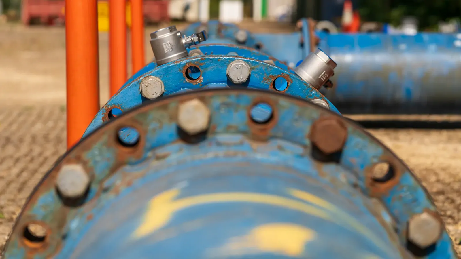 Close-up of flanged pipe joints on an industrial water pipeline