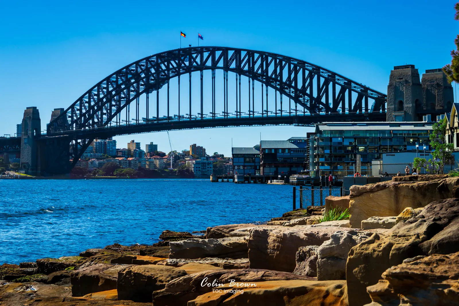 Sydney Harbour Bridge viewed from a rocky shoreline